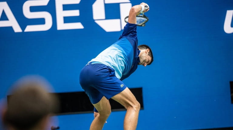 Novak Djokovic breaks his racket after he failed to break...