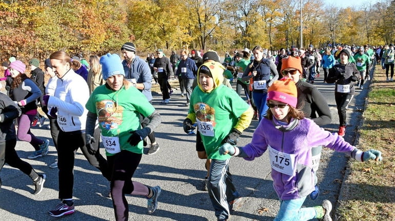 Runners participate in the Turkey Trot at Nissequogue River State...