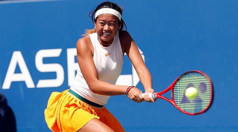 Lea Ma returns against Lenka Stara during a girls' juniors singles...