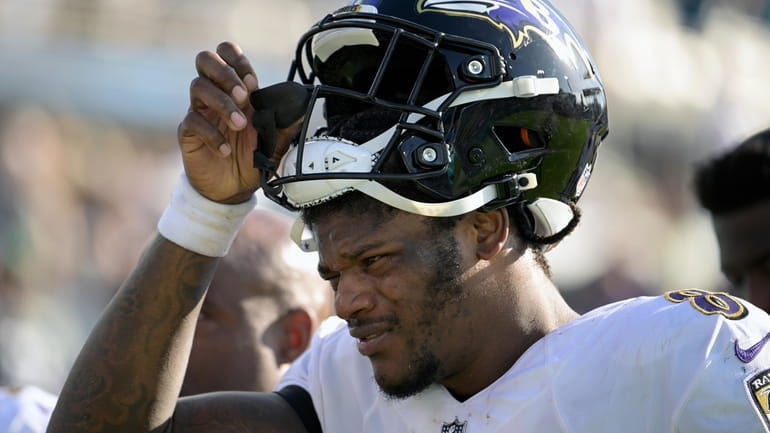 FILE - Baltimore Ravens quarterback Lamar Jackson (8) leaves the...