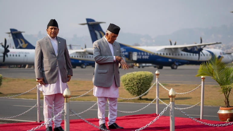 Nepal's President Ram Chandra Poudel checks his watch as he...