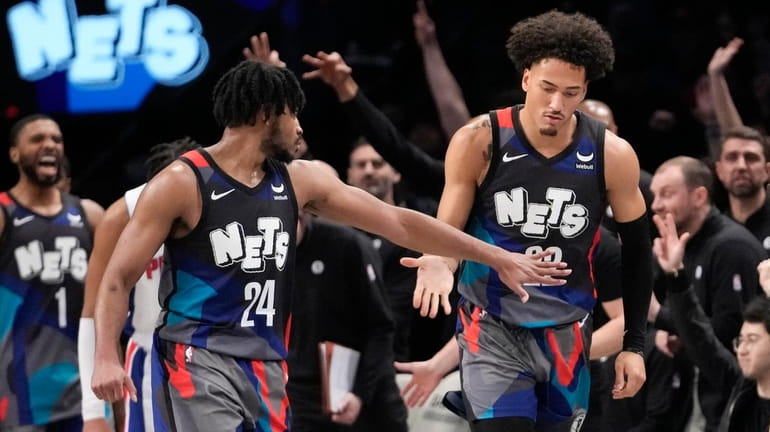 Nets guard Cam Thomas and forward Jalen Wilson react during the...
