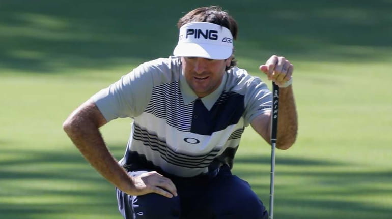 Bubba Watson lines up a putt during the first round...