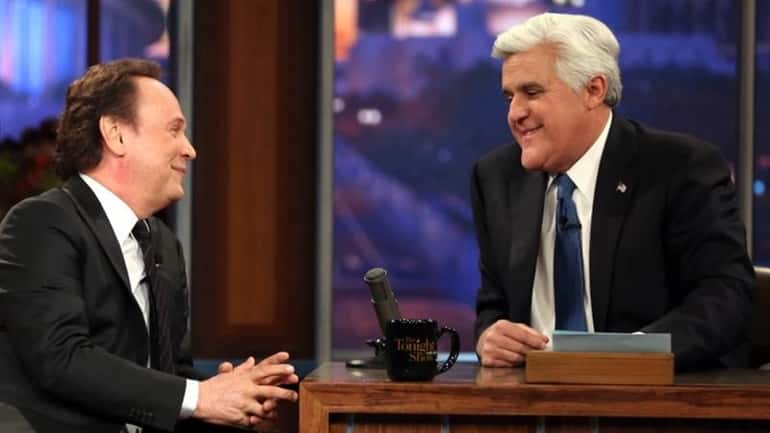 Billy Crystal talks to host Jay Leno during the final...
