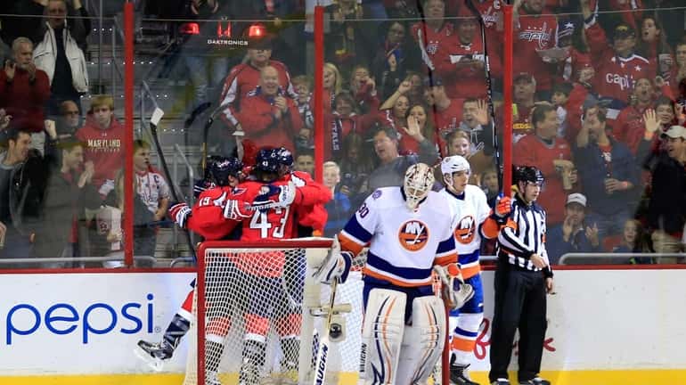 Members of the Washington Capitals celebrate a second-period goal behind...