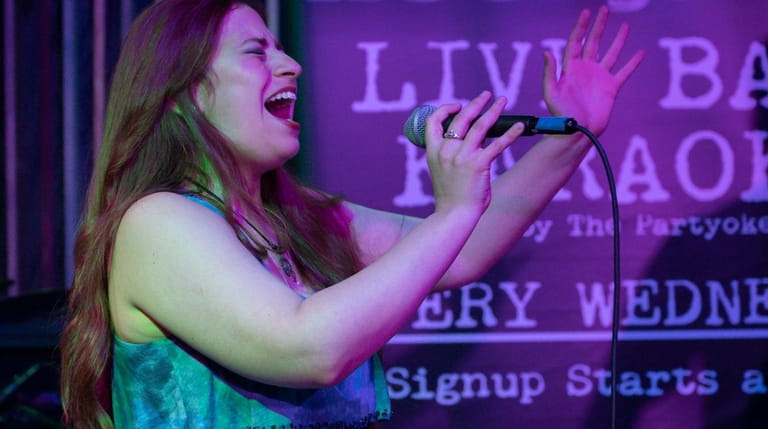 Livvie Leah, 34, of Copiague sings during Live Band Karaoke...