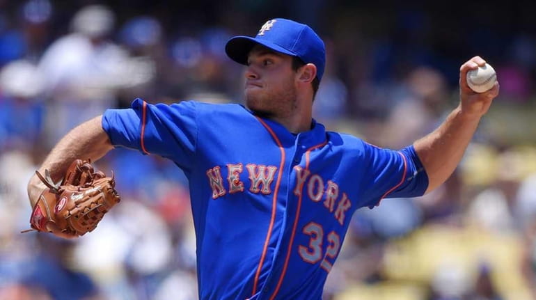 Mets starting pitcher Steven Matz throws to the plate during...