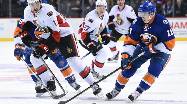 Islanders right wing Ryan Strome skates with the puck against...