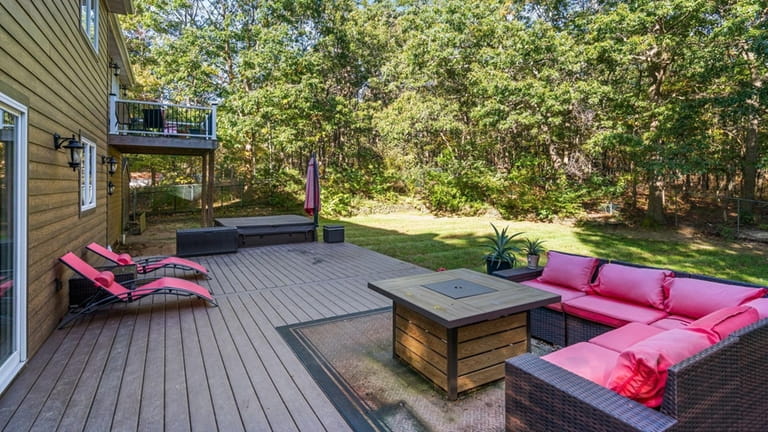 A Trex deck overlooks the backyard, which has enough room...