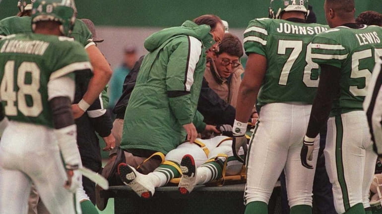 Dennis Byrd of the New York Jets is attended by...