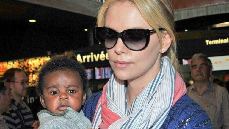 Charlize Theron is photographed holding her son, Jackson Theron, while...