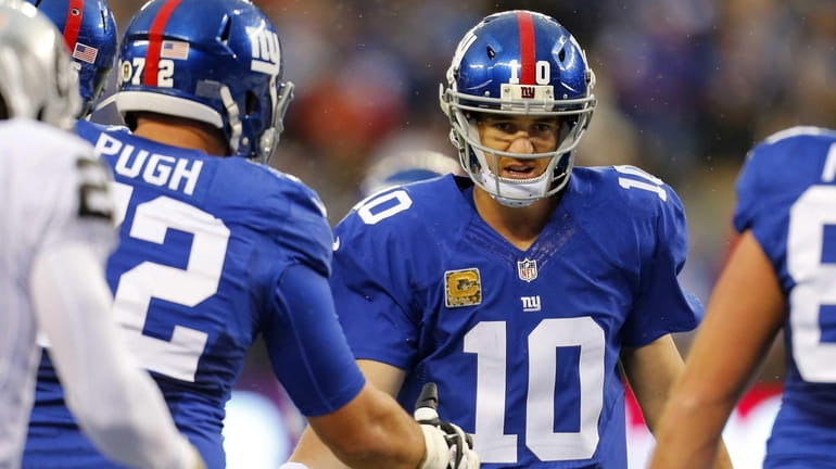Eli Manning celebrates after throwing a touchdown to Rueben Randle...