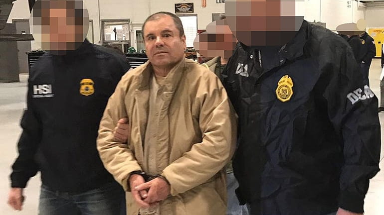 Federal agents escort alleged Mexican drug kingpin Joaquín "El Chapo"...