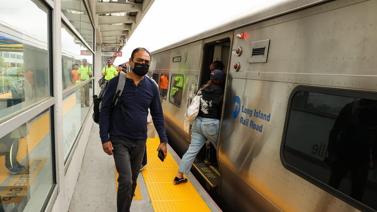 Commuters disembark a Long Island Rail Road train at the...