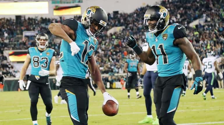 Dede Westbrook and Marqise Lee of the Jaguars celebrate after...