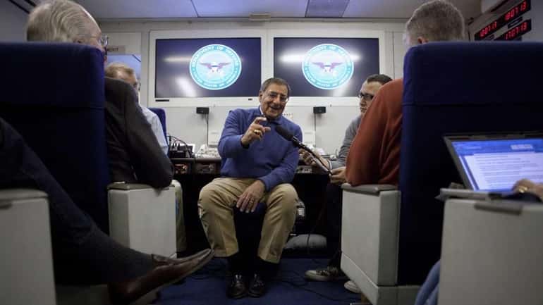 Defense Secretary Leon Panetta briefs the media on board a...