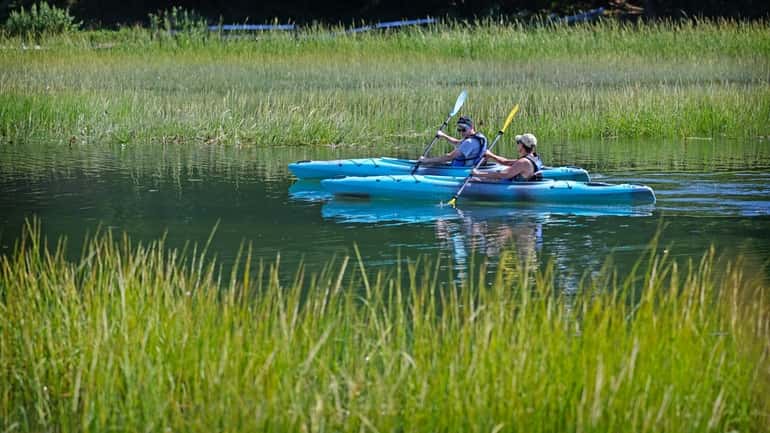 Austin Brodmerkel and Theresa Travers, both of West Islip, paddle their...