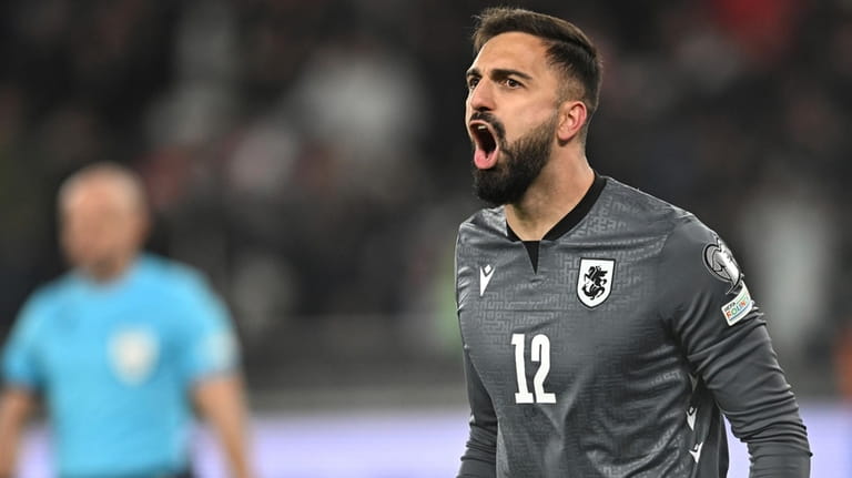 Georgia's goalkeeper Giorgi Mamardashvili reacts after his save during a...