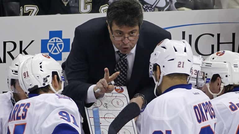 Islanders coach Jack Capuano gives instructions during the third period...