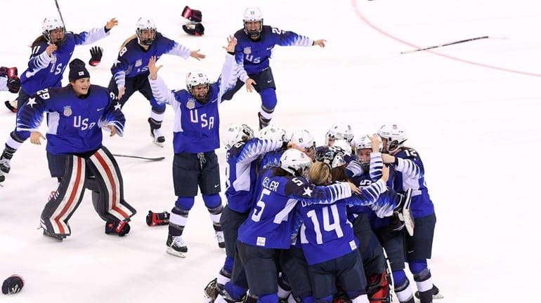 The United States celebrates after defeating Canada in a shootout...
