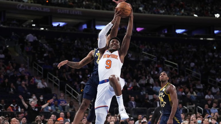 RJ Barrett of the NY Knicks drive to the basket...