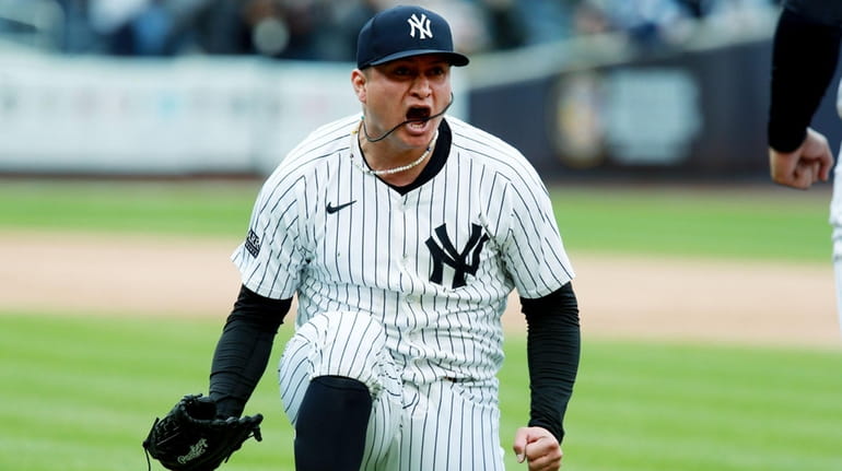 Yankees pitcher Victor Gonzalez reacts after knocking down a hard comebacker...