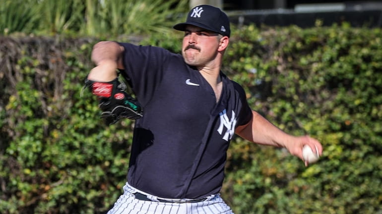 New York Yankees pitcher Carlos Rodon throwing live during practice...