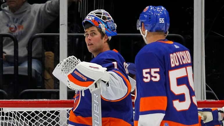Thomas Greiss and Johnny Boychuk of the Islanders look on after...