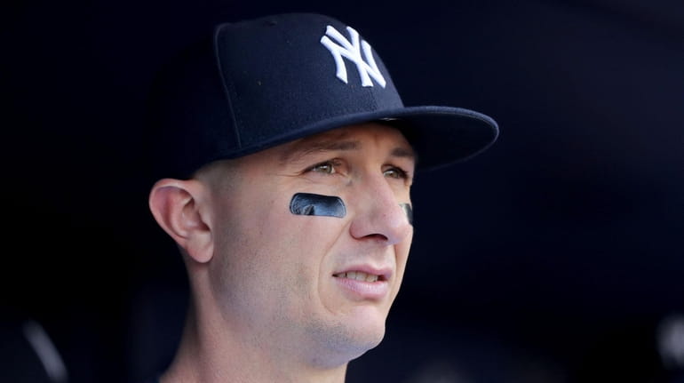 Yankees shortstop Troy Tulowitzki stands in the dugout before a...