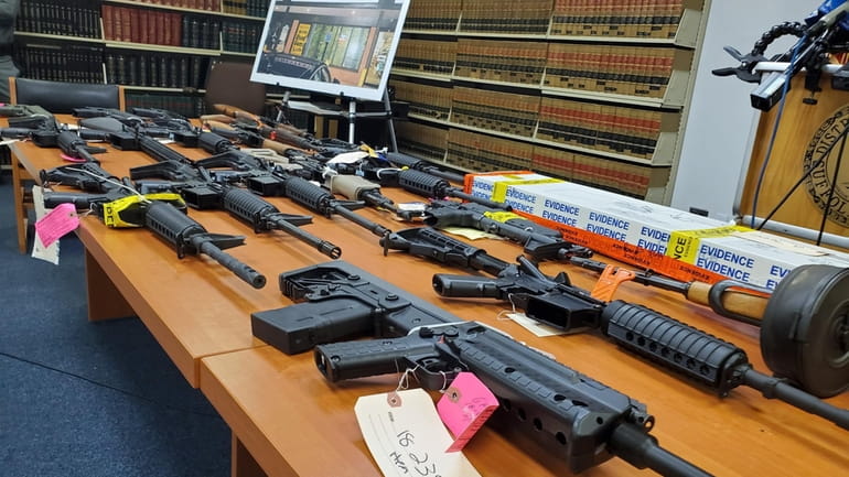 Guns on display during a news conference in the law...