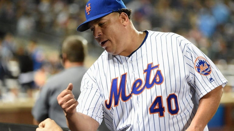 New York Mets starting pitcher Bartolo Colon is greeted at...