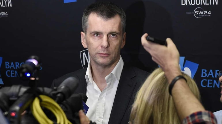 Brooklyn Nets owner Mikhail Prokhorov speaks to the media before...