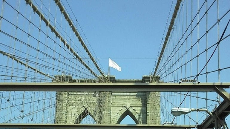 A white flag flutters over the Brooklyn Bridge Tuesday, July...
