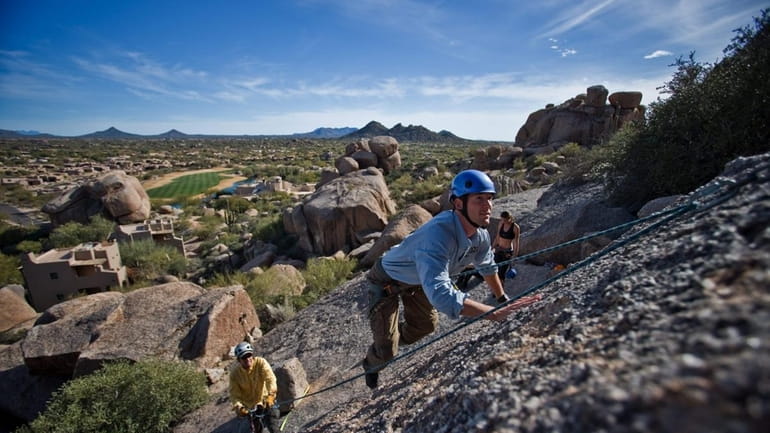 People rock climb at the Boulders Resort in Scottsdale, Arizona....