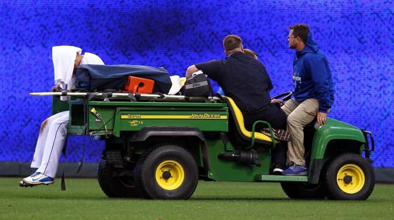 Alex Gordon #4 of the Kansas City Royals is carted...