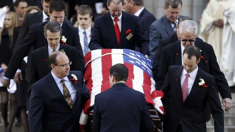 Pallbearers carry the casket containing the body of former St....