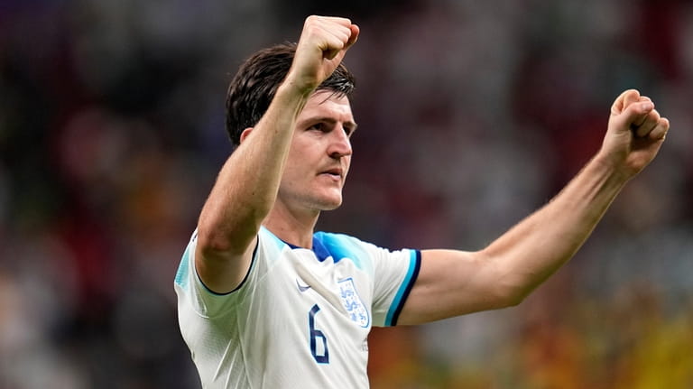 England's Harry Maguire reacts to fans after winning the World...