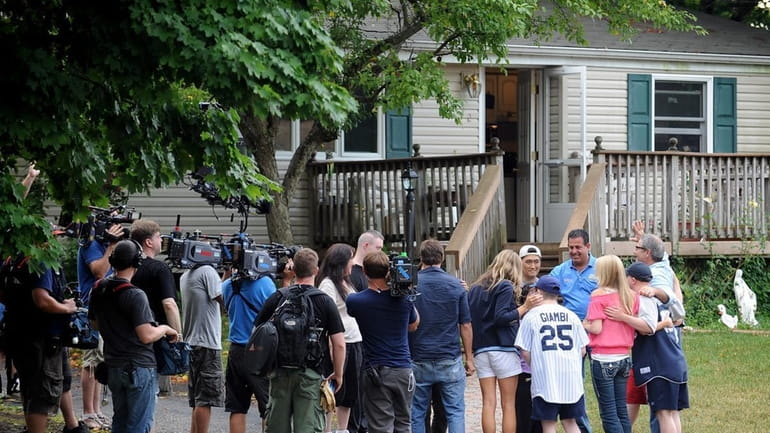 Members of the Lutz family are filmed in front of...