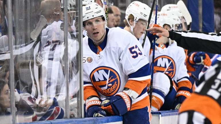 Islanders center Casey Cizikas goes to the bench after an...
