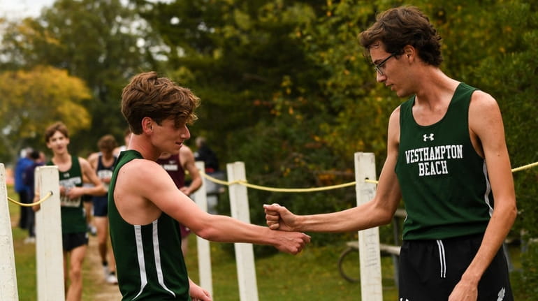 Max Haynia (left) and Gavin Ehlers (right) both of Westhampton congratulate...