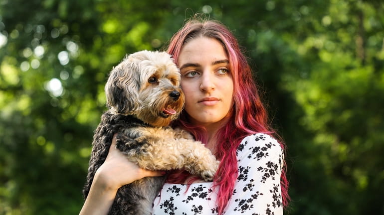 Alexis Spence, 19, of Yaphank, with her service dog, Draco....