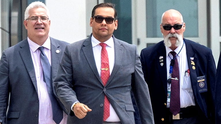 Rep. George Santos (R-Nassau/Queens), center, exits the federal courthouse in...