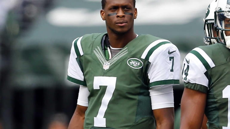 Geno Smith of the Jets looks on from the sidelines...