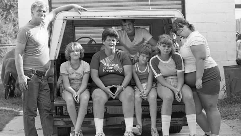 The Koster family and the pickup truck in which they...