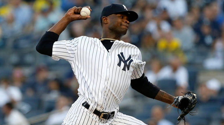 Domingo German of the Yankees pitches in the first inning...