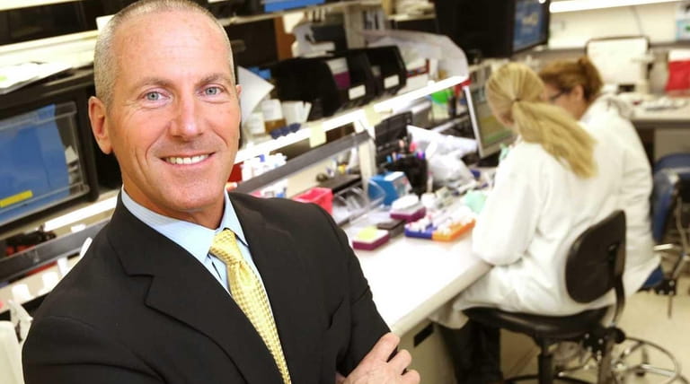 Chembio Diagnostics CEO John J. Sperzel at a company lab...