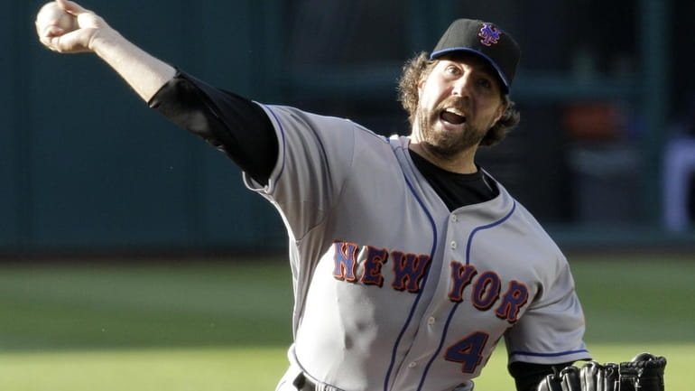 New York Mets' R.A. Dickey works against the Cleveland Indians...