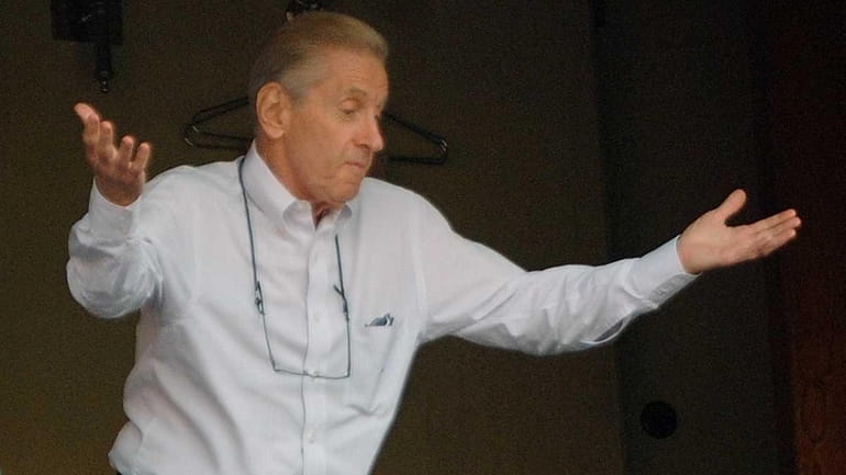 Fred Wilpon gestures as he talks to fans during a...