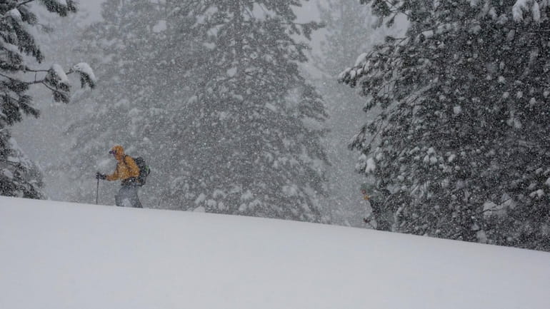 A person skis during a snow storm Sunday, March 3,...