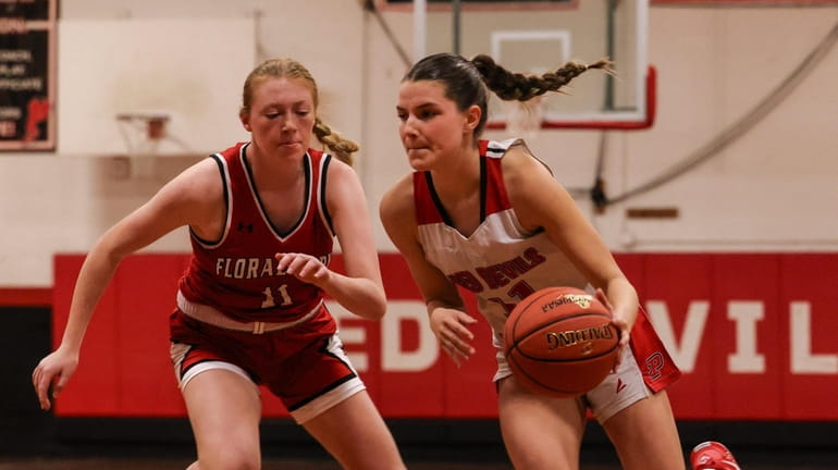 Plainedge's Lucy Younghans drives to the basket with Siena McCree...